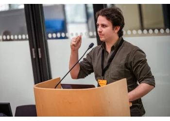 A photograph of Rodrigo Girão Serrão presenting a talk at PyCon Lithuania 2024.