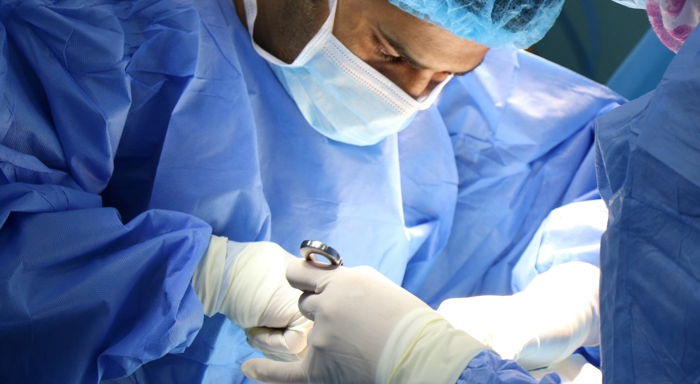 A picture of a doctor wearing latex gloves.