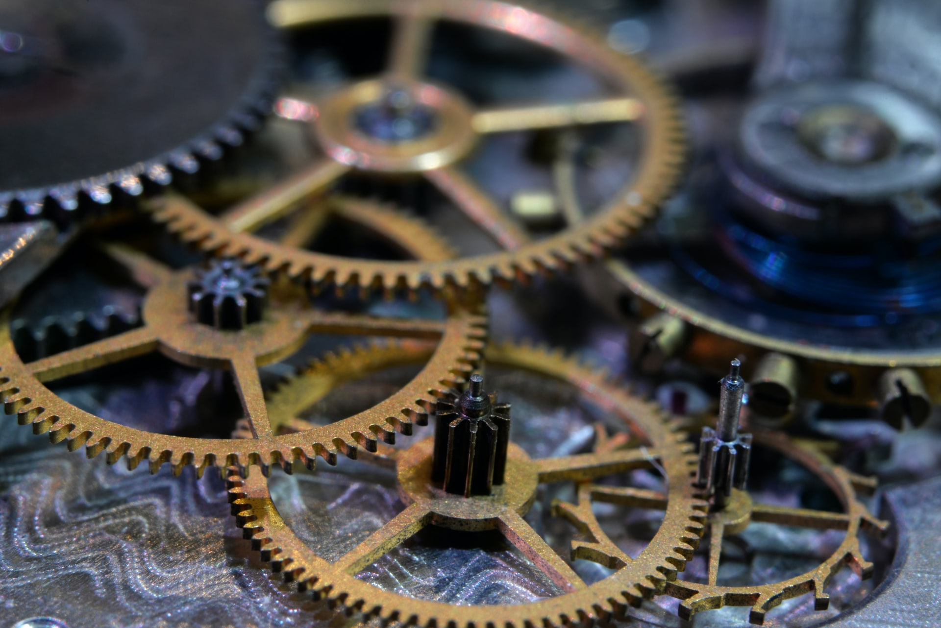 A photo of some gears, a metaphor to how the Python standard module `dis` works and the fact that it allows us to disassemble Python code, letting us understand how Python runs our code under the hood.