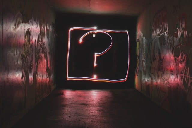 A question mark in a neon light
