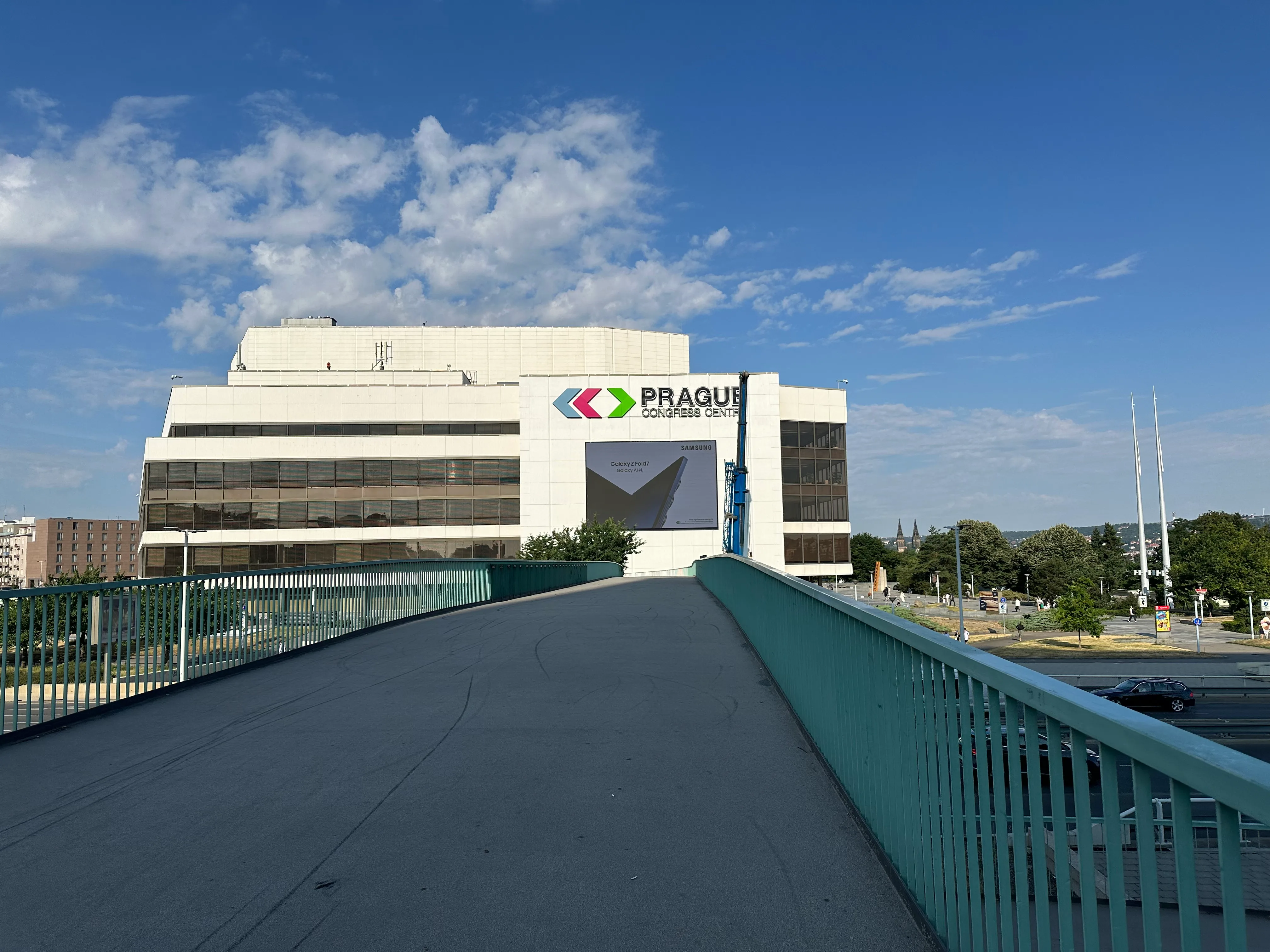 A picture of the Prague Congress Centre at the end of a foot bridge.