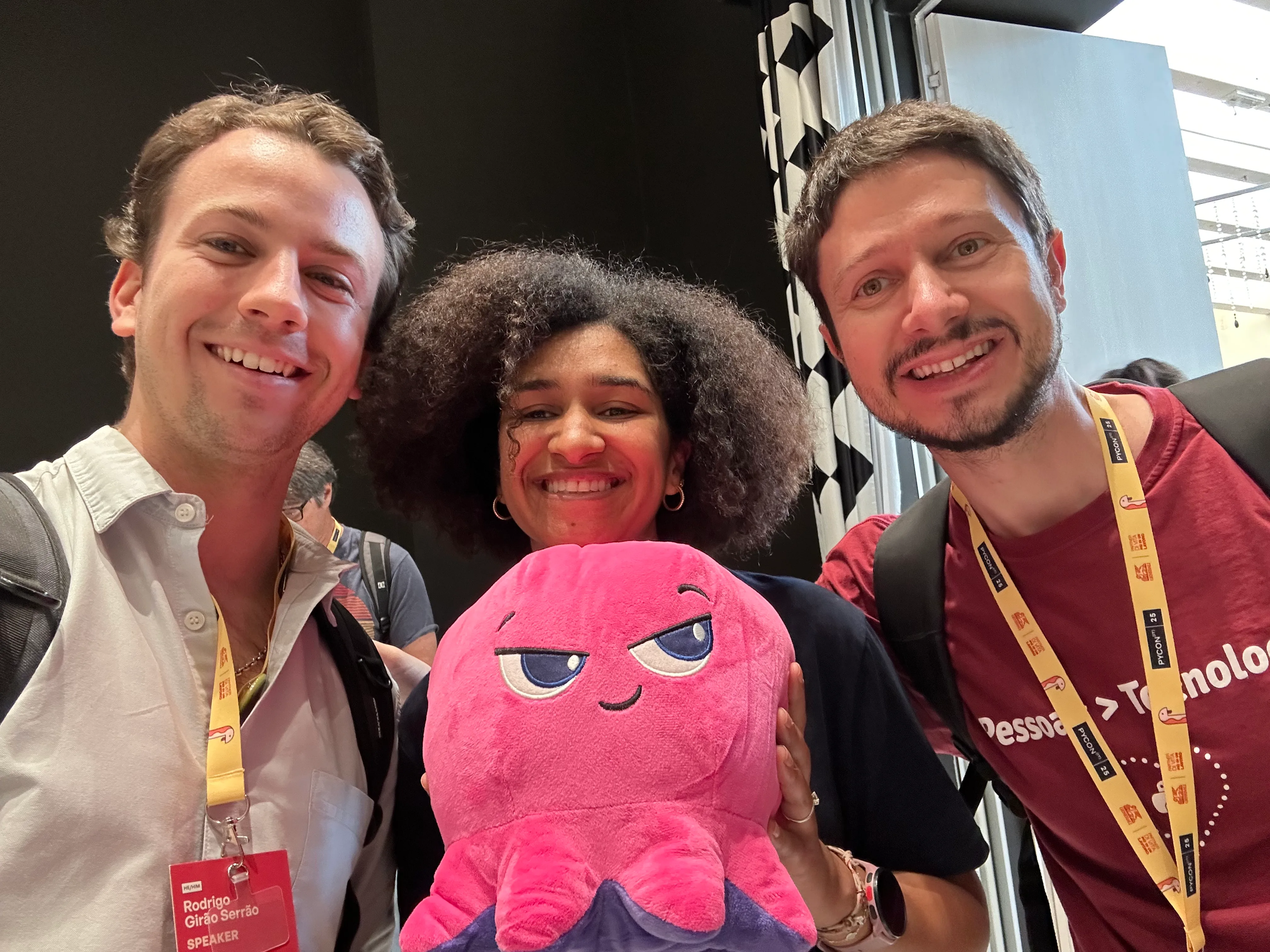Rodrigo with Sarah and Vinícius, holding a large pink octopus plushie.