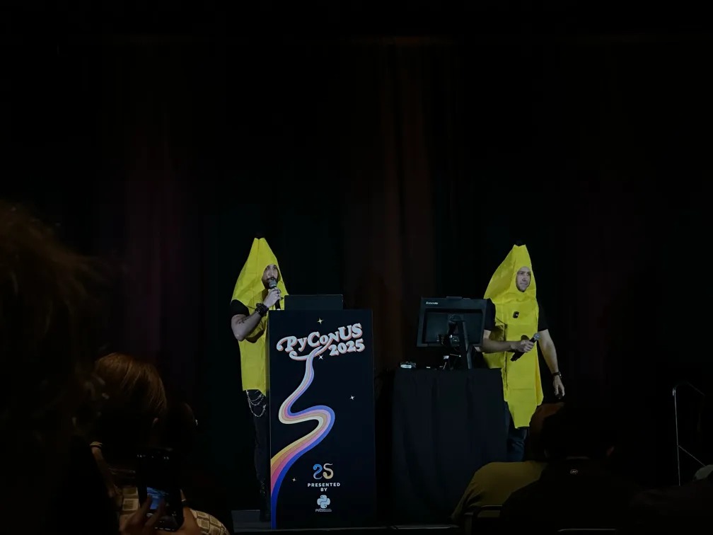 Pablo Galindo Salgado and Yuri Selivanov delivering a talk dressed up as bananas.